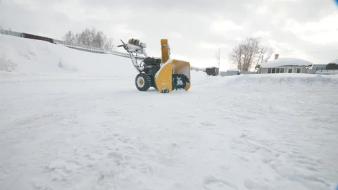 Yellow Snow thrower, winter time, moving camera Stock Footage 125823357