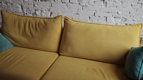 Yellow sofa with blue pillows in a modern interior Stock Footage 313656511