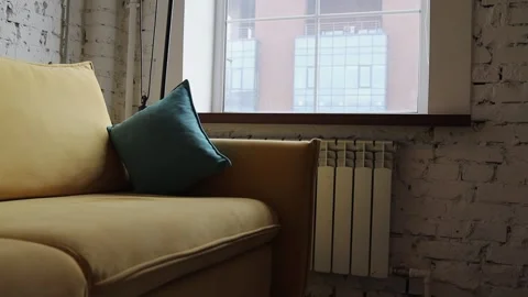 Yellow sofa with blue pillows in a modern interior. Stock Footage 313656520