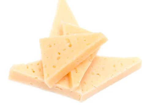 Yellow solid cheese pieces on the white background Foto stock