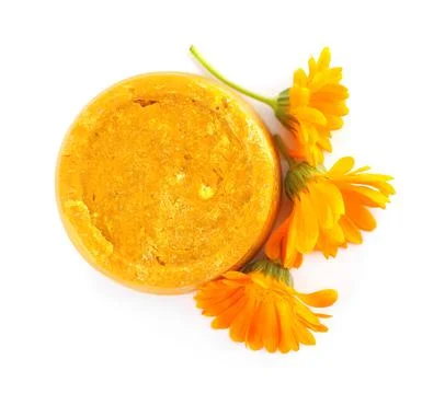 Yellow solid shampoo bar and flowers on white background, top view. Hair care Stock Photos
