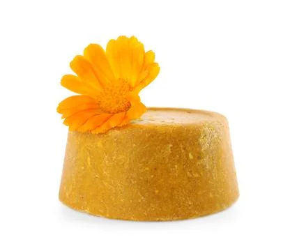 Yellow solid shampoo bar and flower isolated on white. Hair care 写真素材