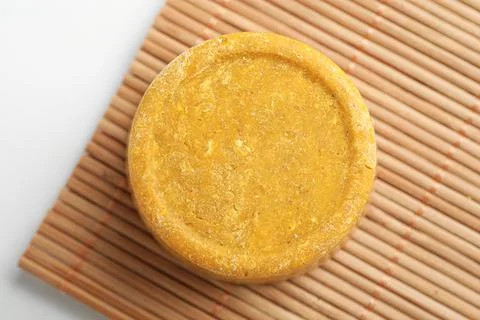 Yellow solid shampoo bar on light table, top view Foto stock