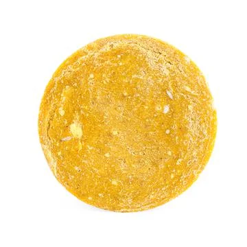 Yellow solid shampoo isolated on white. Hair care 写真素材