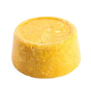 Yellow solid shampoo isolated on white. Hair care Foto stock
