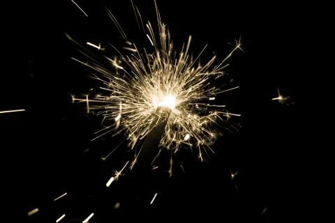 Yellow sparkler countdown on fire with spread of glitter sparks. Luxury enter Stock Photos