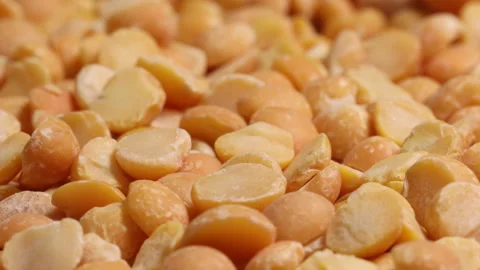 Yellow split chickpea peas boot chana dal lentil pulse bean on white background Stock Footage 133559273
