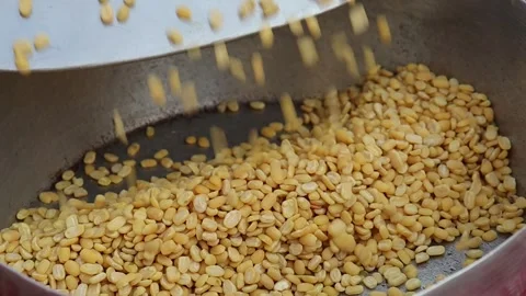Yellow split mung beans pouring from metal scoop Stock Footage 338171401