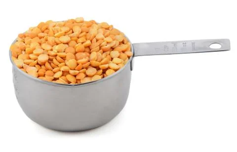 Yellow split peas in a cup measure Stock Photos
