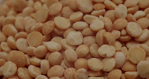 Yellow split peas falling into a bowl on a white background Stock Footage 329293173