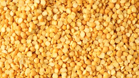 Yellow split peas rotating food background Video stock 342437904