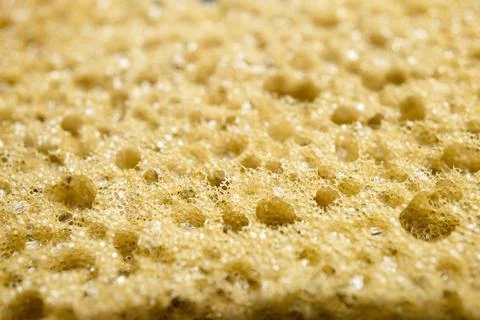 Yellow sponge perforated texture background Stock Photos
