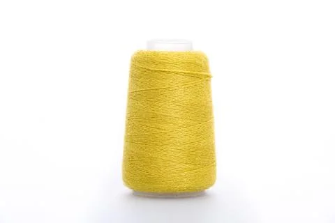 Yellow spool of thread isolated on white background. Skein of woolen threads Stock Photos