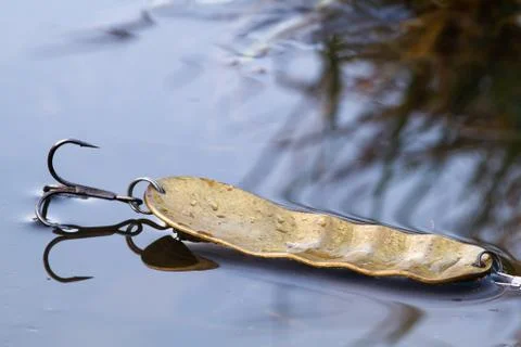 Yellow spoon lying on thin autumn ice Stock Photos