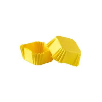 Yellow square paper baking forms for muffins and cupcakes Stock Photos