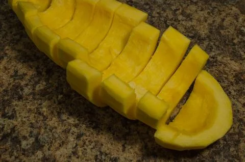 Yellow squash without seeds cut into pieces ready for cooking close-up Stock Photos