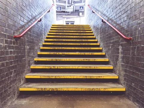 Yellow steps at train station Stock Photos