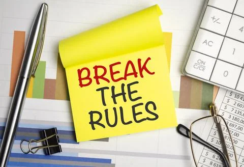 Yellow sticker with the text break the rules and charts Stock Photos