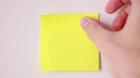 Yellow sticker on white surface Stock Footage 84885062