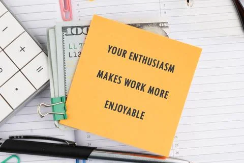 Yellow sticky note with enthusiasm improves work clipped to a stack of bills, Stock Photos