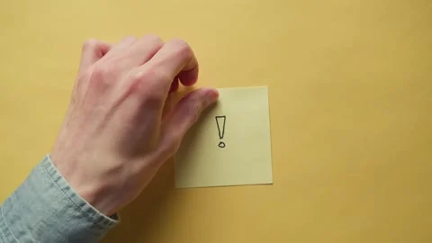 Yellow sticky note with exclamation point drawn on it Stock Footage 320555784