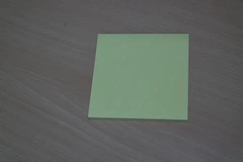 Yellow sticky note paper placed on a wooden table Stock Photos