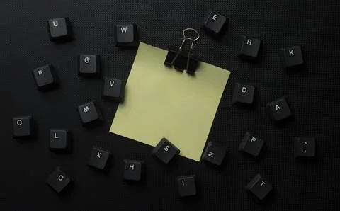 Yellow Sticky Note With Scattered Keyboard Keys On Black Background Stock Photos