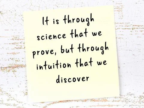 Yellow sticky note with smart quotation handwritten on it hanging on wooden w Photos