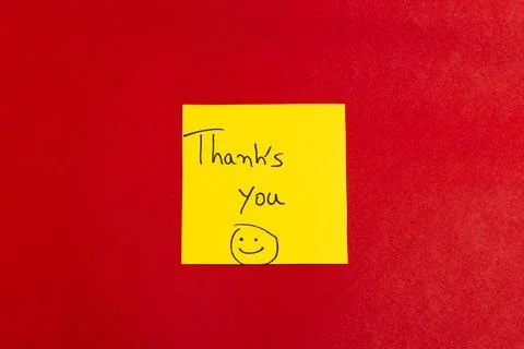 A yellow sticky note with a smiley face and the words "Thank you" written on  Stock Photos