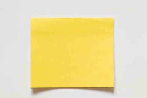 Yellow sticky note on white background for notes as background, reminders, .. Stock Photos