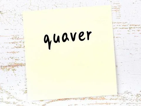 Yellow sticky note on wooden wall with handwritten inscription quaver Stock Photos