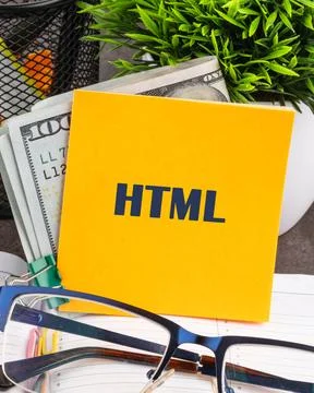 Yellow Sticky Note With the Word HTML Placed Next to Cash and Eyeglasses on.. Stock Photos