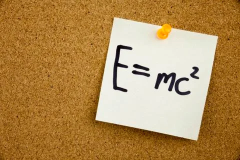 A yellow sticky note writing, caption, inscription EQUATION E EQUAL MC2 in bl Foto stock