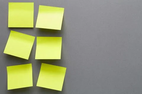 Yellow Sticky Notes On Grey Paper Background Stock Photos