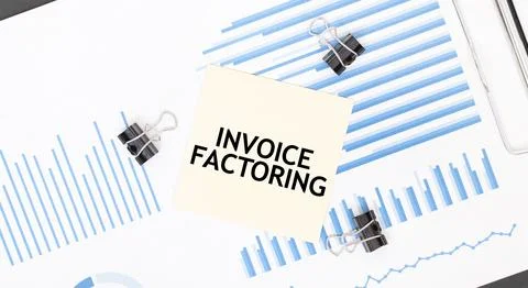 Yellow sticky notes with text INVOICE FACTORING on the white office desk. B.. Fotos Stock