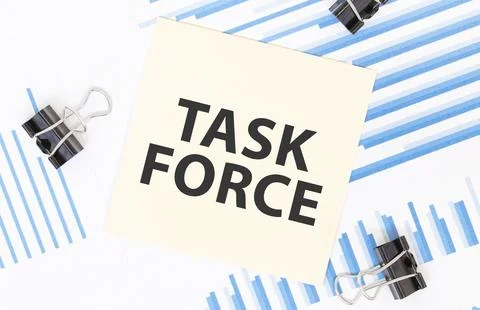 Yellow sticky notes with text TASK FORCE on the white office desk. Business.. Stock Photos