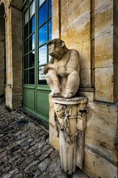 Yellow stone monkey statue in the courtyard of the Buffon Museum in Montbard. Stock Photos