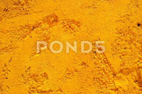 Yellow stone wall background Stock Photos
