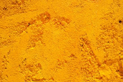 Yellow stone wall background Stock Photos