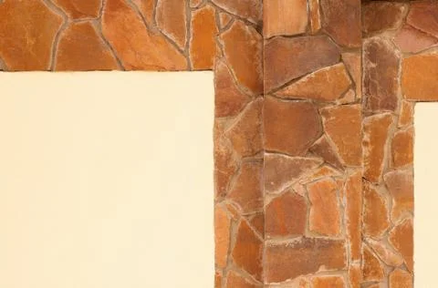 Yellow stone wall with plaster Stock Photos