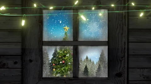 Yellow string lights flashing over window with view of christmas tree and Stock Footage 310924831