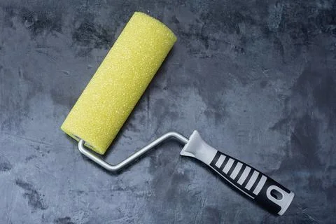 Yellow structural paint roller for creating textured decorative finishes on.. Stock Photos
