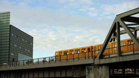A yellow subway train in Berlin drives over a bridge. Stock Footage 221425535