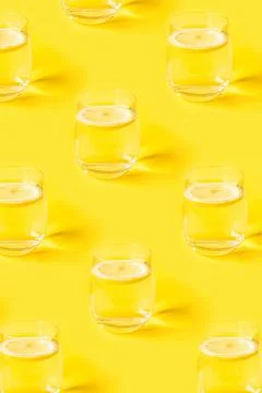 Yellow summer pattern with glasses of lemonade. Stock Photos