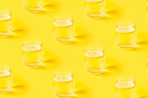 Yellow summer pattern with glasses of lemonade. Stock Photos