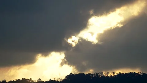 Yellow sun behind clouds during sunset. Stock Footage 264348162