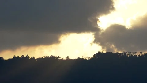 Yellow sun behind clouds during sunset. Stock Footage 264348240