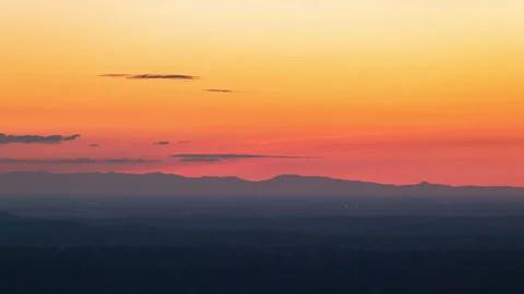 Yellow Sun Sets Over Central Valley as City Lights Appear Timelapse Stock Footage 278524617