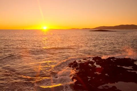 Yellow sunset and waves Stock Photos