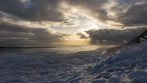 Yellow sunset and waves Stock Photos